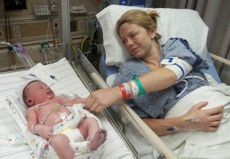 A nurse wheeled Jamie into the NICU so she could touch Jackson for the first time. The blue tint of his right foot is a sign of the heart problems he was born with. (Photo courtesy of the Dawson family)